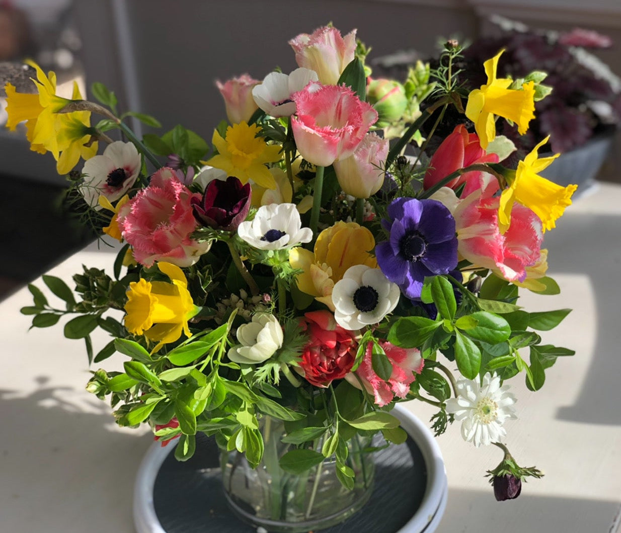 Bouquet of flowers in a vase on a table with text overlay.