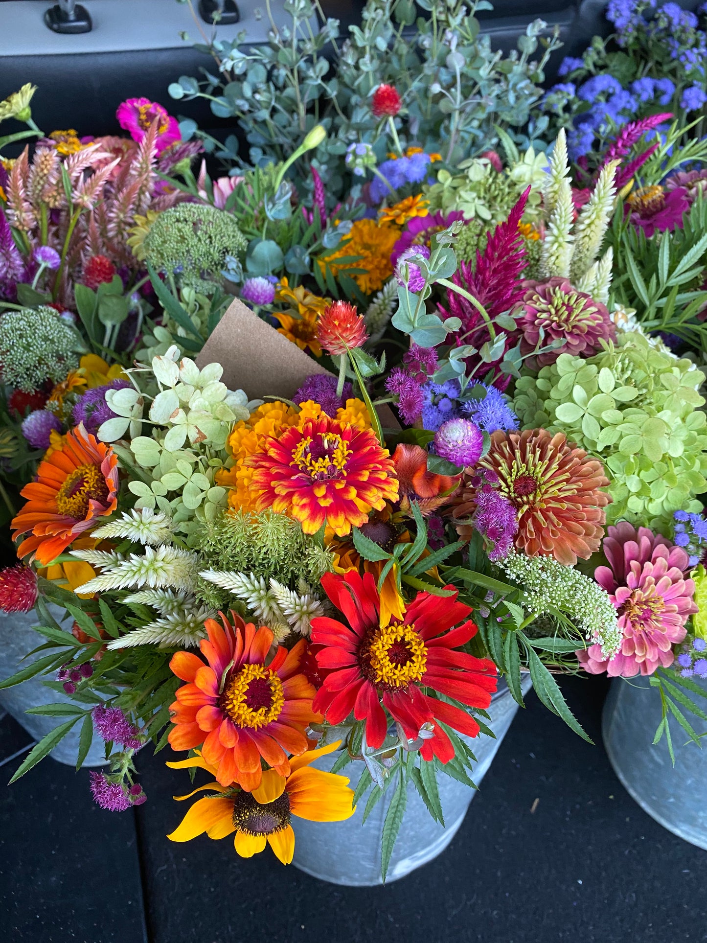 Colorful bouquet of flowers with a focus on red, orange, and yellow flowers.